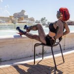 Domina Detroit Michigan red and black heels in chair outside